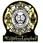 Gold coloured medallion with black background reading Fire Rescue.